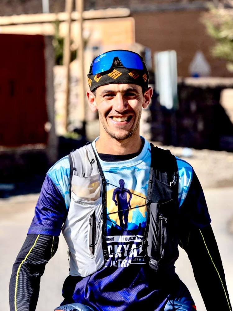 Saïd smiling, wearing his trail running vest in Imlil