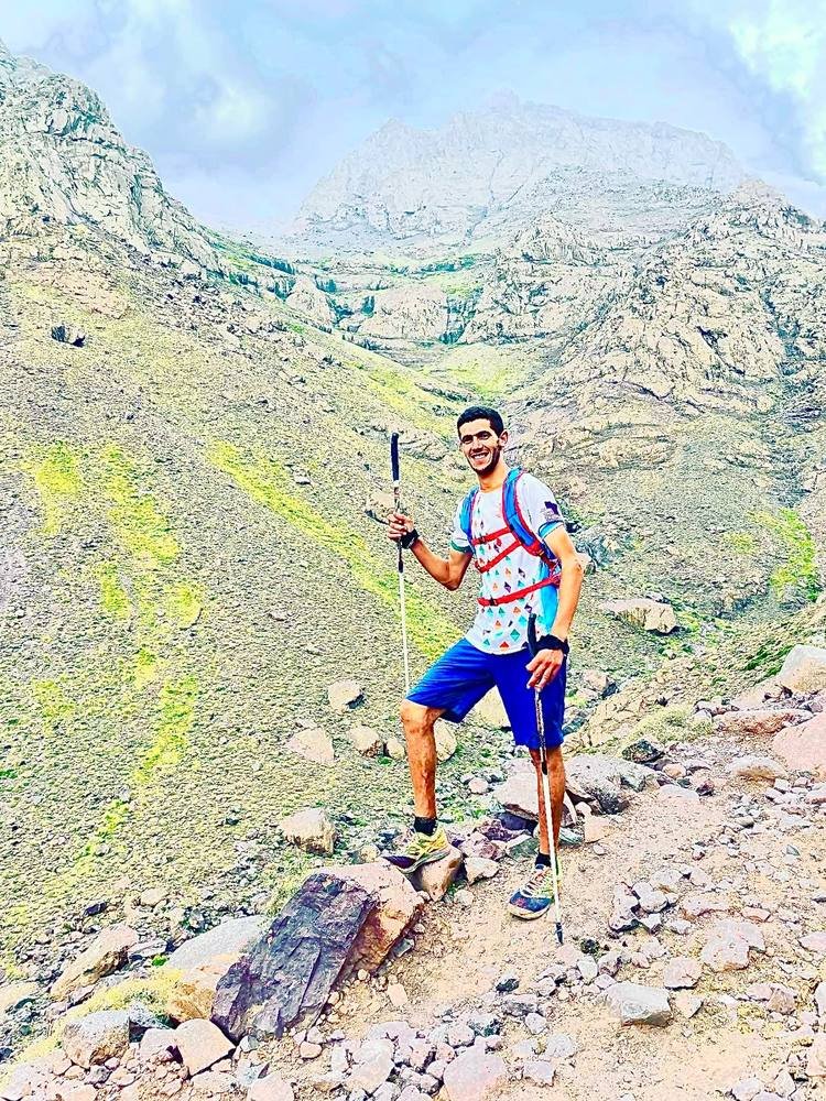 Saïd trekking with poles on a High Atlas mountain trail